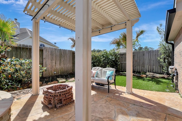 view of patio featuring a fenced backyard, a pergola, and an outdoor fire pit