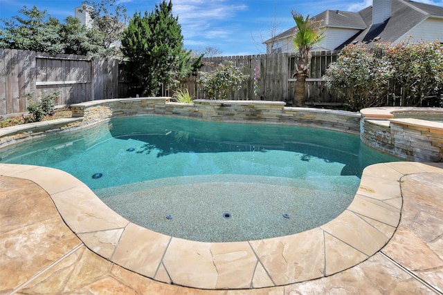 view of swimming pool featuring an in ground hot tub, a fenced backyard, and a fenced in pool