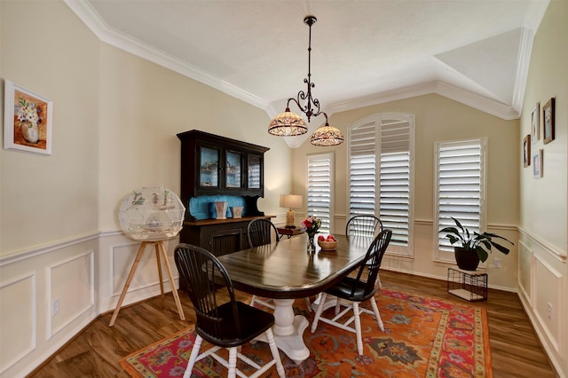 dining room with a wainscoted wall, wood finished floors, and ornamental molding