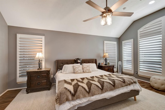 bedroom featuring baseboards, wood finished floors, a ceiling fan, and vaulted ceiling