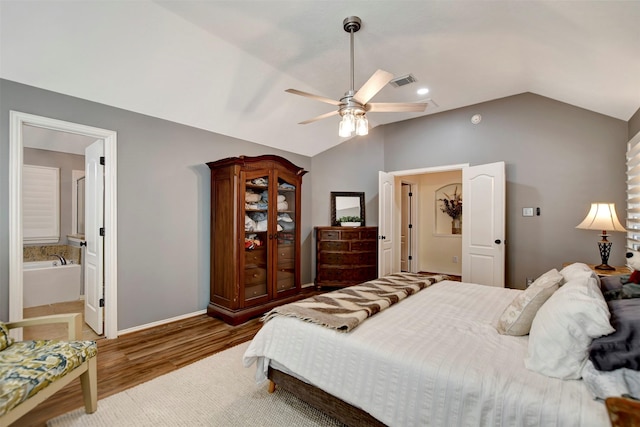 bedroom with visible vents, baseboards, ceiling fan, vaulted ceiling, and wood finished floors