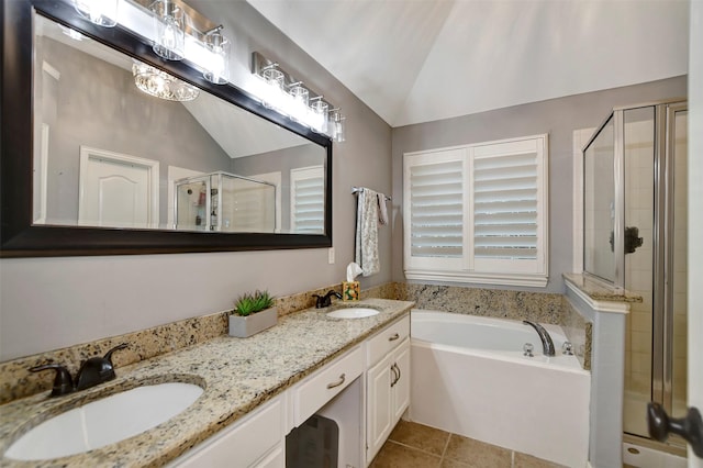 bathroom with lofted ceiling, a garden tub, a shower stall, and a sink