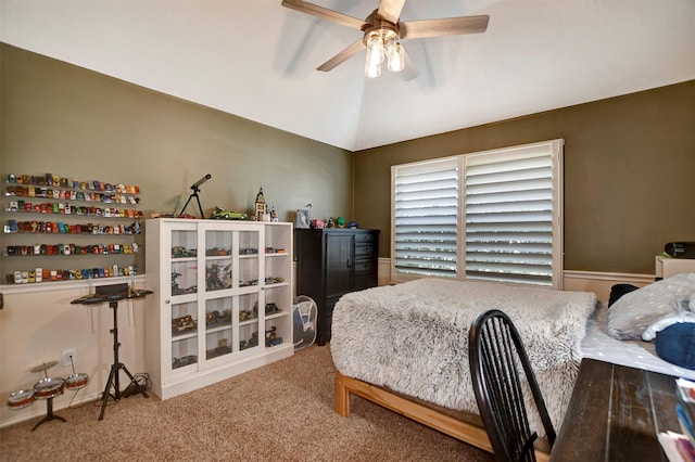 carpeted bedroom with ceiling fan and vaulted ceiling