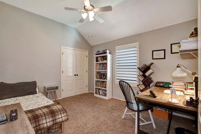 carpeted office space with lofted ceiling, a ceiling fan, and baseboards