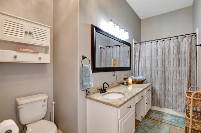 bathroom featuring vanity, tile patterned floors, and toilet