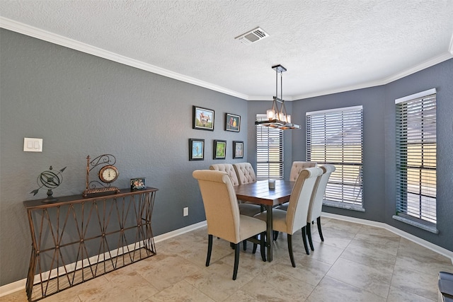 dining space featuring visible vents, baseboards, ornamental molding, and a textured wall