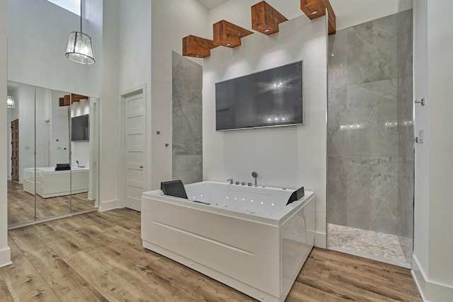 interior space featuring wood finished floors and a towering ceiling