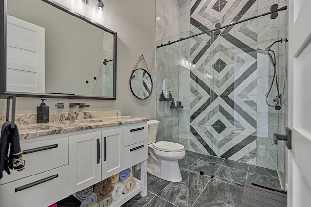 full bath featuring vanity, a shower stall, and toilet