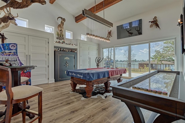 playroom with beam ceiling, light wood-type flooring, and high vaulted ceiling