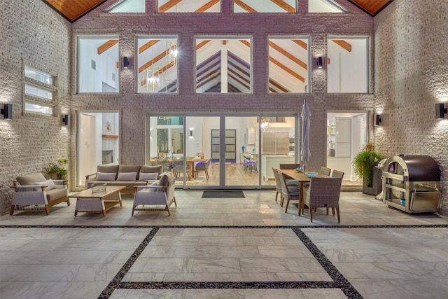 exterior space featuring a grill, outdoor lounge area, and french doors