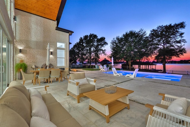 view of patio featuring an outdoor living space, outdoor dining area, a fenced in pool, and fence