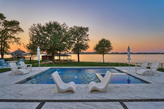 pool at dusk with a patio area, a fenced in pool, a yard, and fence