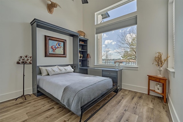 bedroom with baseboards and light wood finished floors