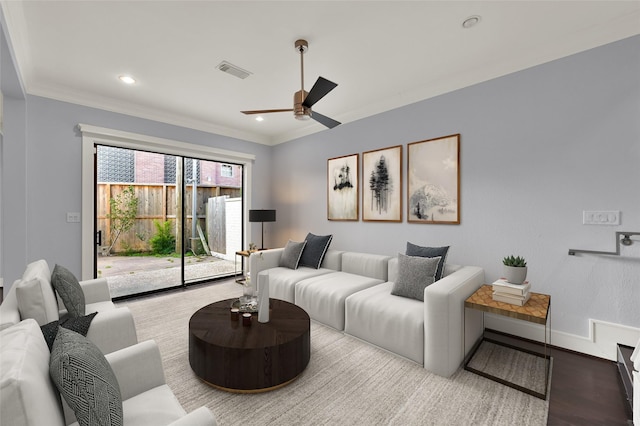 living area featuring wood finished floors, visible vents, baseboards, recessed lighting, and crown molding