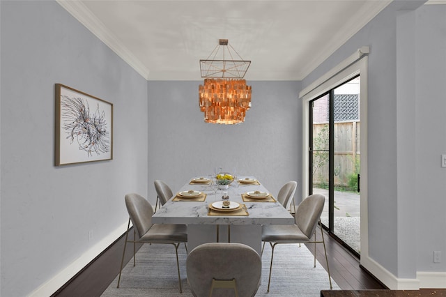 dining room with baseboards, a notable chandelier, dark wood finished floors, and crown molding