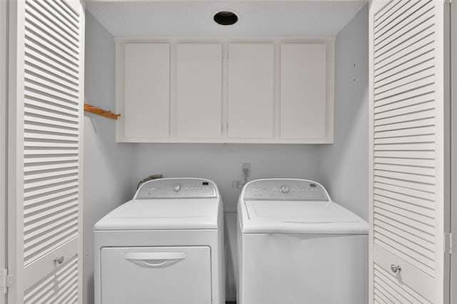 laundry room with cabinet space and separate washer and dryer