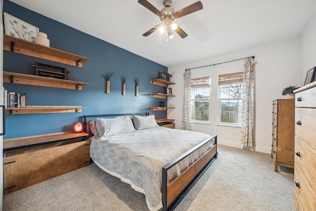 carpeted bedroom with baseboards and ceiling fan