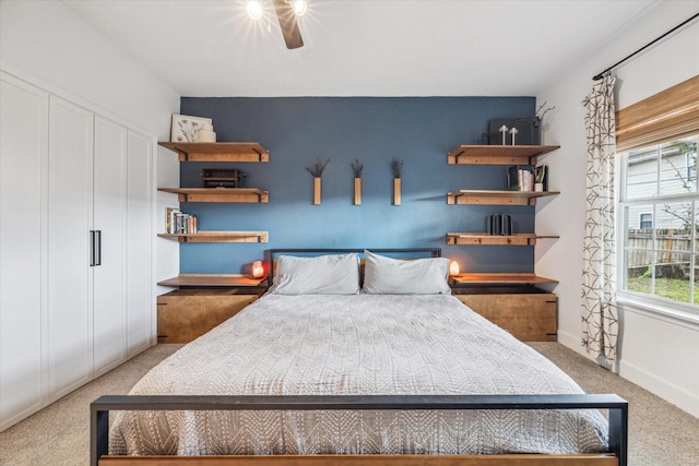 bedroom with carpet flooring, a ceiling fan, a closet, and baseboards