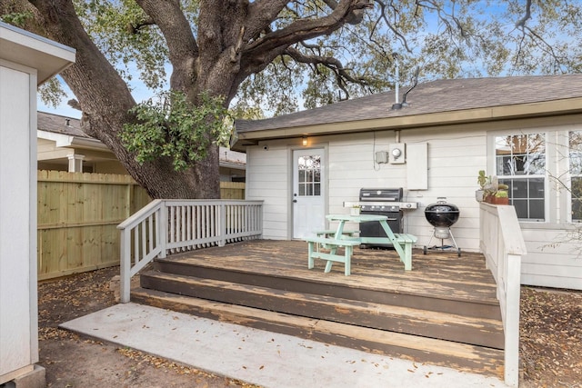 wooden deck featuring a grill and fence