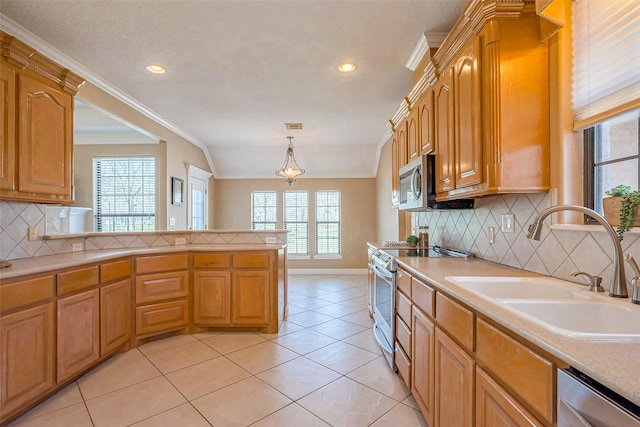 kitchen with light tile patterned floors, a sink, ornamental molding, light countertops, and stainless steel appliances