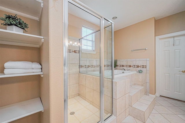 full bathroom featuring tile patterned floors, a bath, and a shower stall