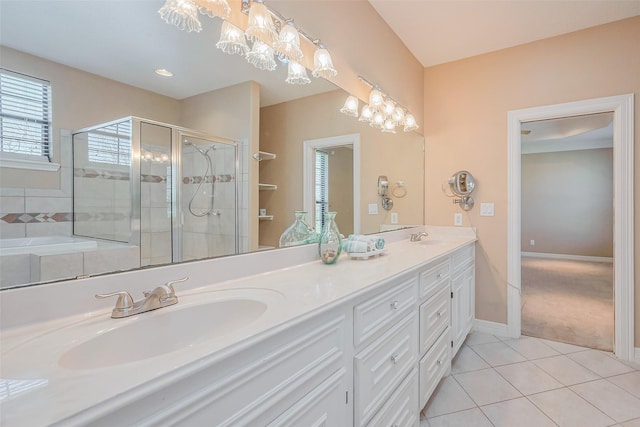 full bath with a sink, double vanity, a stall shower, and tile patterned floors