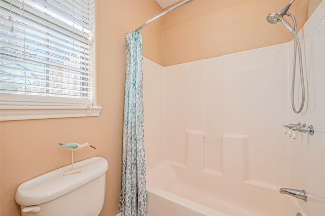 bathroom featuring toilet and shower / tub combo