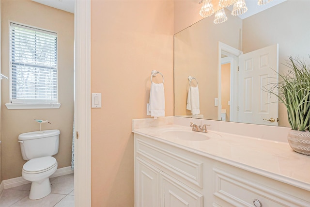 bathroom featuring tile patterned floors, a notable chandelier, toilet, baseboards, and vanity