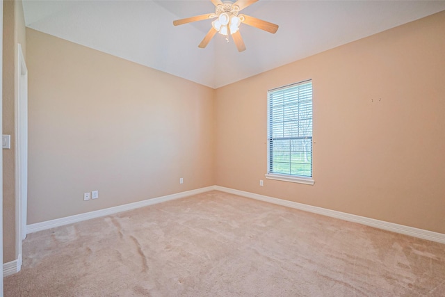 spare room featuring ceiling fan, lofted ceiling, baseboards, and carpet floors