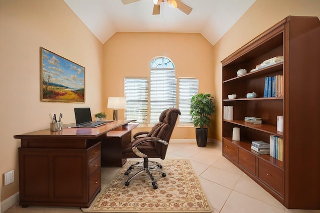 home office with vaulted ceiling, light tile patterned flooring, baseboards, and ceiling fan