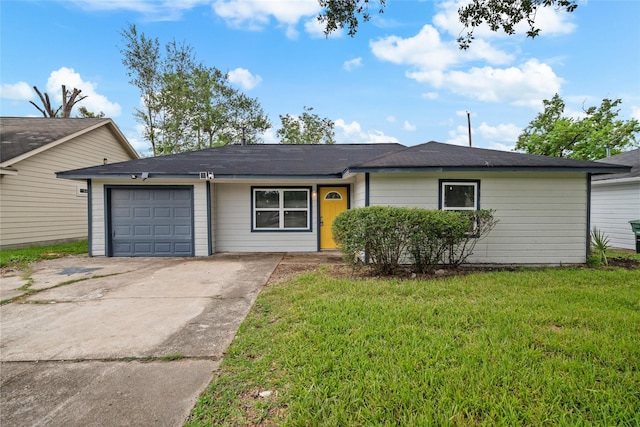 single story home featuring concrete driveway, a garage, and a front yard