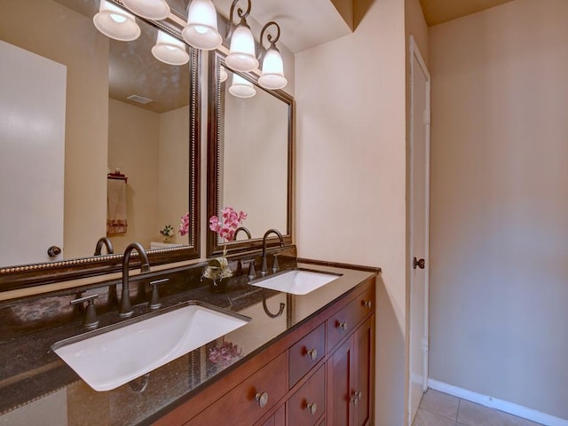 full bathroom featuring a sink, visible vents, double vanity, and tile patterned floors