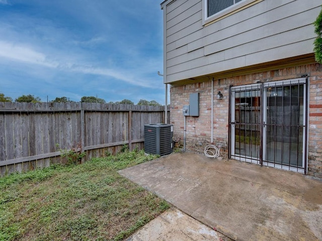 view of yard featuring central AC unit, a patio, and a fenced backyard
