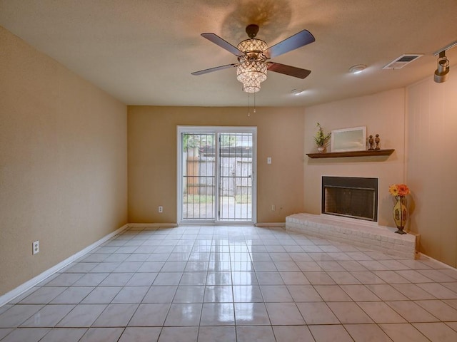 unfurnished living room with visible vents, baseboards, light tile patterned flooring, a fireplace, and ceiling fan