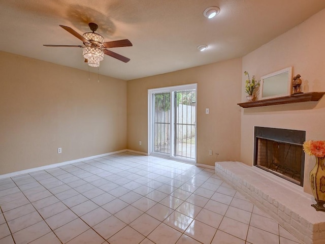 unfurnished living room with a ceiling fan, light tile patterned floors, a fireplace with raised hearth, and baseboards