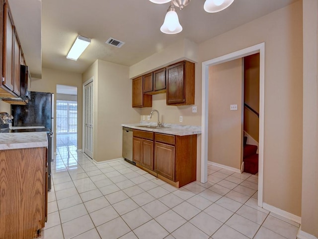 kitchen with a sink, visible vents, appliances with stainless steel finishes, and light countertops