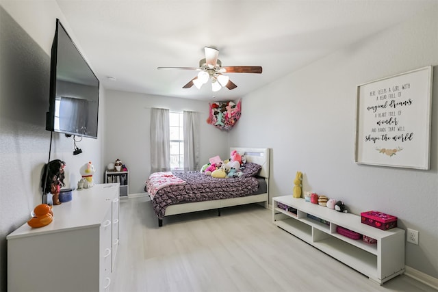 bedroom with baseboards, wood finished floors, and a ceiling fan