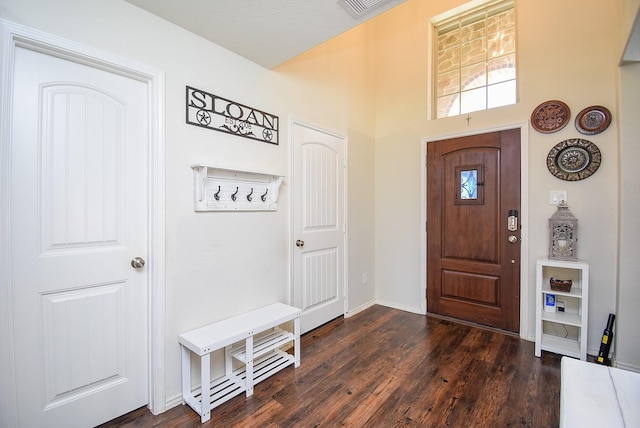 entrance foyer with baseboards and dark wood-style floors