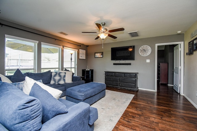 living area with visible vents, ceiling fan, baseboards, and wood finished floors