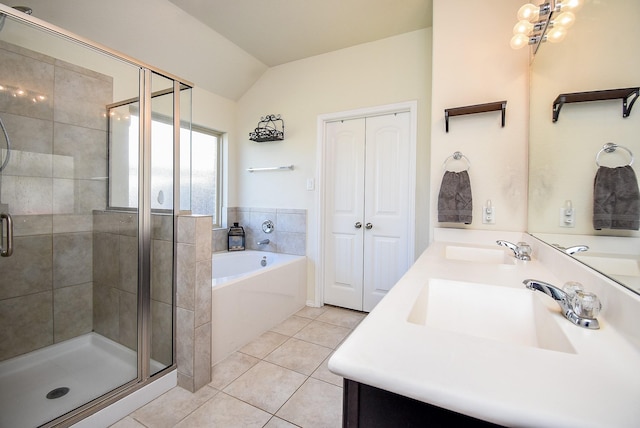 bathroom featuring tile patterned flooring, a bath, a stall shower, and a sink