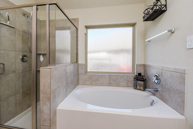 bathroom featuring a bath and a stall shower