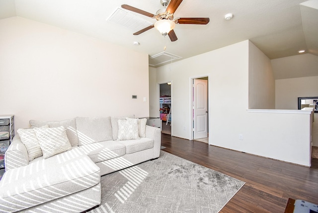 living room with wood finished floors, attic access, a ceiling fan, and vaulted ceiling