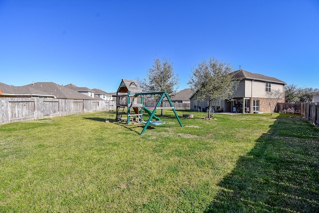 view of yard featuring a playground and a fenced backyard