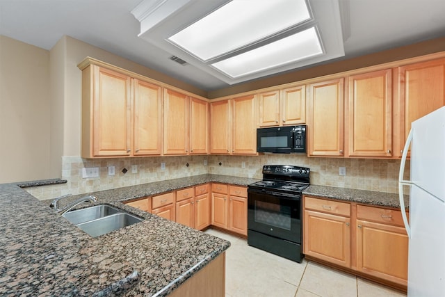 kitchen with visible vents, black appliances, light brown cabinets, a sink, and decorative backsplash