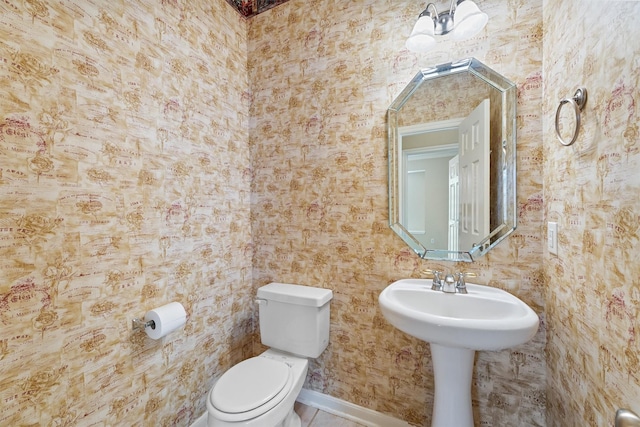 bathroom featuring toilet and a sink