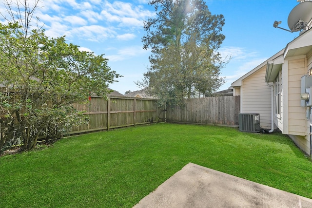 view of yard with central AC unit and a fenced backyard