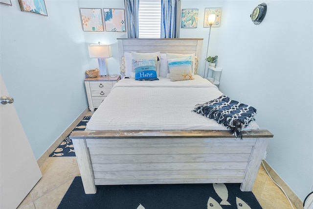 bedroom featuring baseboards and tile patterned flooring