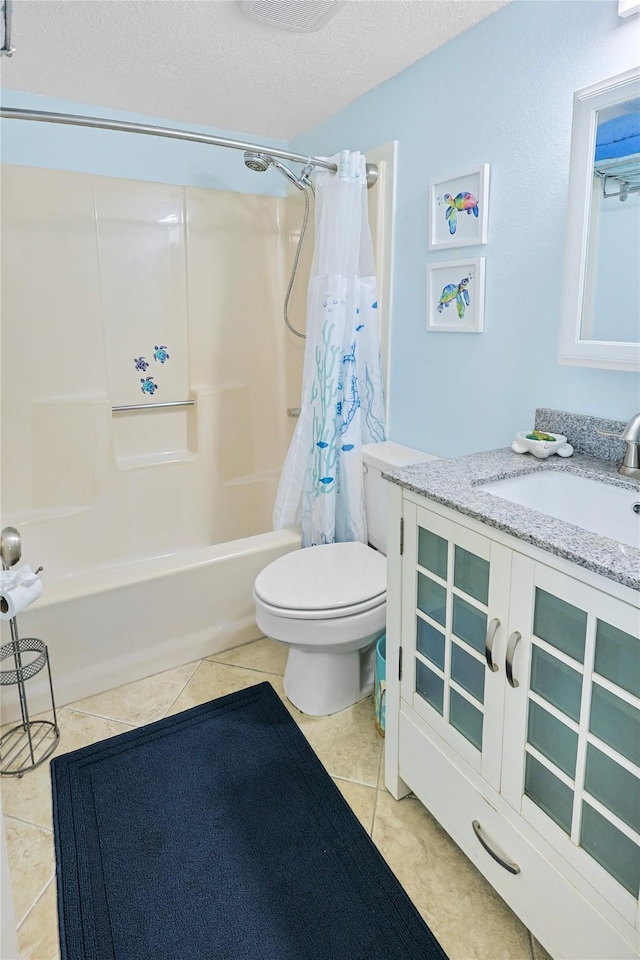 full bathroom featuring vanity, shower / bath combo, a textured ceiling, tile patterned floors, and toilet