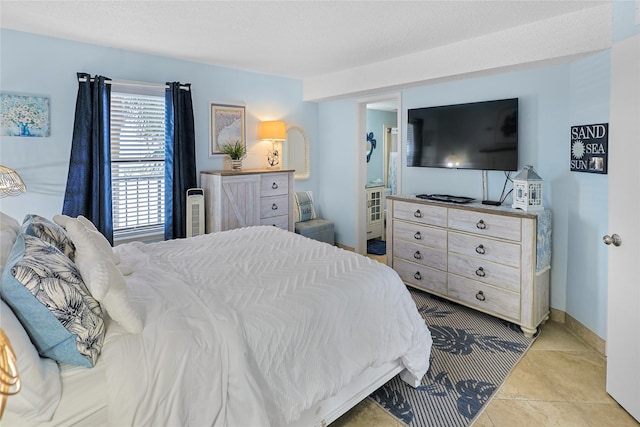 bedroom with tile patterned flooring and baseboards