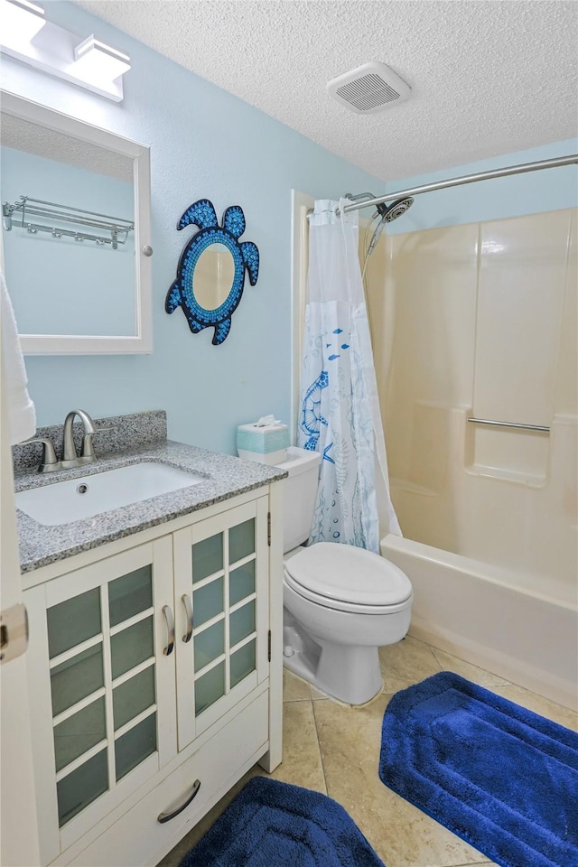 bathroom with visible vents, toilet, shower / tub combo with curtain, a textured ceiling, and vanity